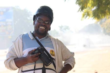 Crispen Ndlovu carrying a camera
