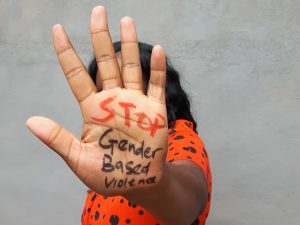 Woman hold out hand with inscription 'stop gender violence'